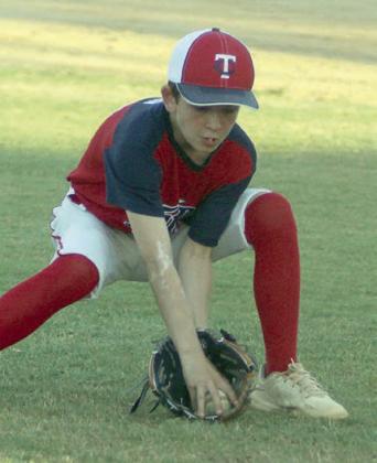 Pitcher Luke Goedrich fields a bunt in the third inning. Sticker Photo By Darrell Vyvjala