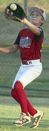 Jaxon Kurtz snags a fly ball in right field in the third inning. Sticker Photo By Darrell Vyvjala
