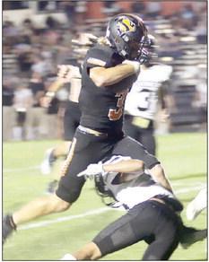Aaron Janecek steps over an Eagle defender on his 20-yard touchdown run in the second quarter. Sticker Photo By Layne Vyvjala