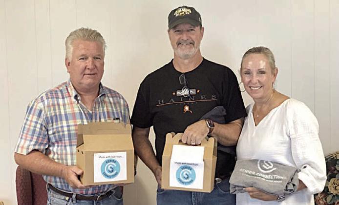 The August baking group prepared goodie boxes for the Helping Heroes – (photo at left, from left) Carl Penland and Craig and April Pierson – for their hard work and dedication to members, and also for Tanya and Joe Schindler of South Central Real Estate who donated 22 chickens and three turkeys (photo at right), which will make a lot of meals for Senior Connections!