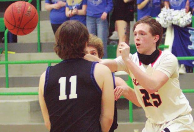 Kenny Schramek dishes to a teammate on a second-half drive. Sticker Photo By Layne Vyvjala