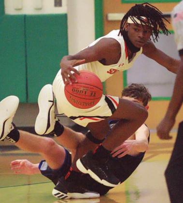Kenny King comes away with a loose ball for a steal in the second quarter. Sticker Photo By Layne Vyvjala