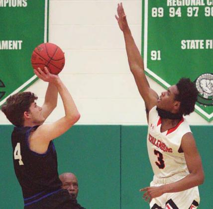 Bryce Wilson goes up to get a piece of Conner Kreutziger’s shot in the first quarter. Sticker Photo By Layne Vyvjala