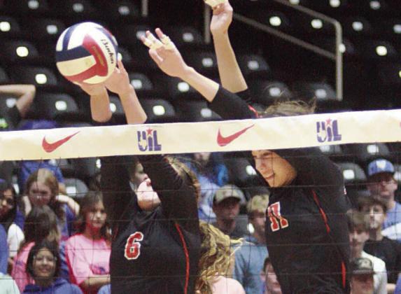 Tamara Otto (left) and Meredith Magliolo team up for a block in the first set. Sticker Photo By Layne Vyvjala