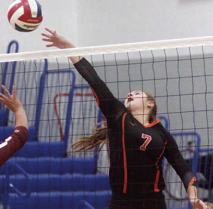 Landry Zapalac tips a ball over in the first set. Sticker Photo By Darrell Vyvjala