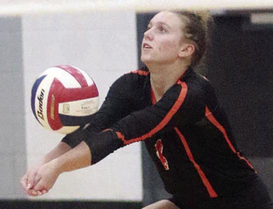 Avery Helms picks up a dig in game one. Sticker Photo By Darrell Vyvjala