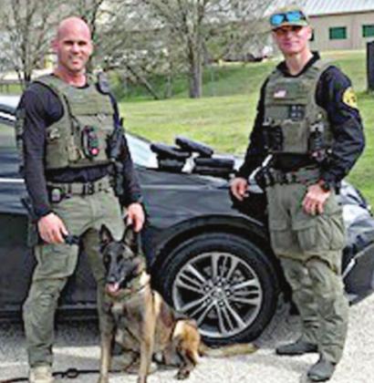 Sgt. Randy Thumann, his K-9 partner Kolt and Investigator David Smith with 5.45 kilos of cocaine recovered after Sgt. Thumann initiated a traffic stop on a black Toyota Camry on Interstate 10 near Flatonia. The driver sped off and during an 11-mile pursuit, threw bricks of cocaine out the window.