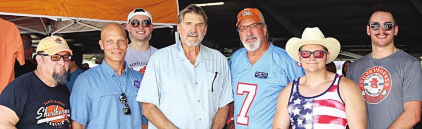 Members of Shorthorns Forever Association pose with former NFL quarterback Dan Pastorini (center) under the Pavilion on Saturday afternoon. The appearance of the Houston Oiler great was sponsored by Bigham Law Firm. Pastorini’s autographs helped the organization with its fund-raising efforts during the Festival. Posing with Pastorini are: (from left) Dale Manning, Chip Bubela, Mickey Olle; and (from right) Montana Olle, Dalton Manning, and Mike Olle. Photo By Sandy Kusy/A Thousand Words Photography