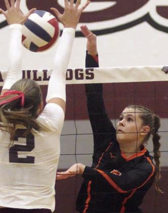Haylee Vacek sends a kill cross-court past a Lady Bulldog in the fifth set. Sticker Photo By Darrell Vyvjala
