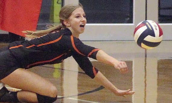 Clara Magliolo dives for a dig in the first set against Flatonia. Sticker Photo By Darrell Vyvjala