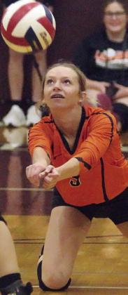 Michaela Kollmann goes to the floor to get to a Lady Bulldogs attack in game four. Sticker Photo By Darrell Vyvjala