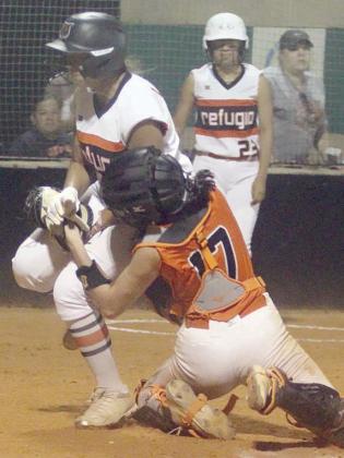 Catcher Kassidy Kubala tags out a Lady Bobcat trying to score in the top of the sixth inning of game 3. She took the throw from centerfielder Rilee Sanchez and was able to hang on to the ball after the collision in front of home plate. Sticker Photo By Darrell Vyvjala