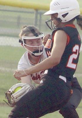 Shortstop Haylie Goode tags a Lady Bobcat trying to steal third base in the top of the third inning of game one. Sticker Photo By Darrell Vyvjala