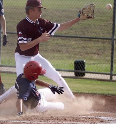 Dylan Zweschper slides home to score a run on a wild pitch in the top of the first inning last Tuesday. Sticker Photo By Darrell Vyvjala