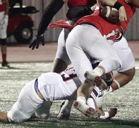Cooper Demel cuts down Cody Sells for no gain in the first quarter. Sticker Photo By Layne Vyvjala