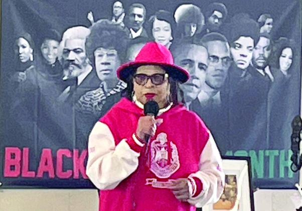 Dr. Virginia Glass Berry, with a backdrop of the most influential African-Americans in the country’s history, gives the keynote address at Saturday’s Black History Month Celebration. Sticker Photo By Darrell Vyvjala