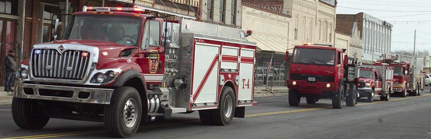 Several trucks of the Schulenburg Volunteer Fire Department take part in the parade. Sticker Photo By Darrell Vyvjala