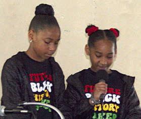 Blayke and Blayre Miller read the poem Hey Black Child. Sticker Photo By Darrell Vyvjala