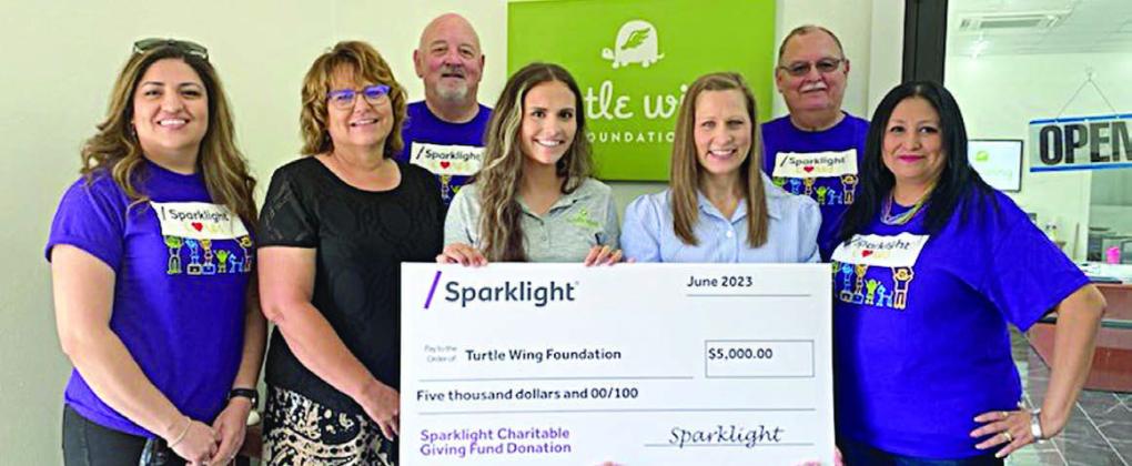 Shown at the presentation of a $5,000 grant from Sparklight to Turtle Wing Foundation are (from left) Gloria Rodriquez, Sparklight representative; Kim Miori, program director, Turtle Wing; John Kubos, Sparklight representative; Destiny Psencik, executive director, Turtle Wing; DeeAnn Hooper, founder/ president, Turtle Wing; Martin Schooley, Sparklight representative; and Melinda Gutierrez, Sparklight representative.