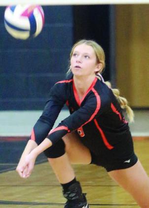 Michaela Kollmann sends a pass on its way in the first set against Shiner. Sticker Photo By Darrell Vyvjala