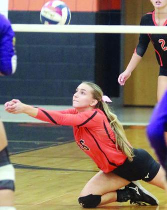 Jenna Guentert makes a lunging dig in game one against Shiner. Sticker Photo By Darrell Vyvjala