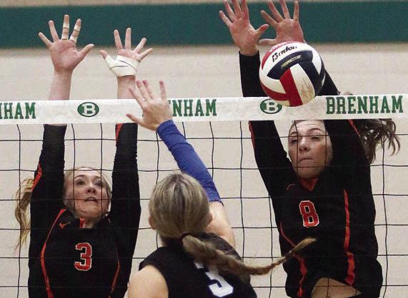 Reagan Dusek (left) and Greenli VanZandt in set three. Sticker Photo By Darrell Vyvjala