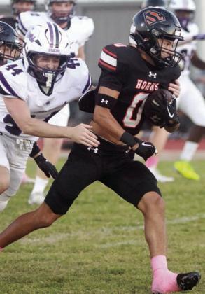 Denver Carr slips a tackle on his way to a first-quarter touchdown. Sticker Photo By Darrell Vyvjala