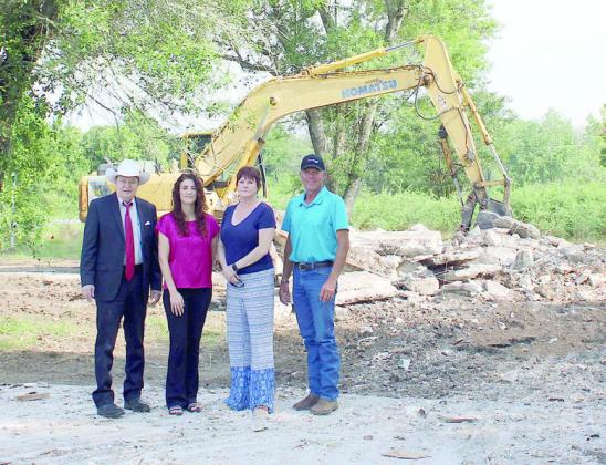 Homes in the La Grange area damaged by flooding caused by Hurricane Harvey are in the process of being demolished. Fayette County was able to purchase the properties where the work is being done through the Buyout Program administered by the General Land Office. Shown are (from left) County Judge Dan Mueller; Cassie Austin, court sdministrator; Angela Hahn, emergency management coordinator and grants specialist; and Harvey Berckenhoff, Commissioner, Precinct 3.