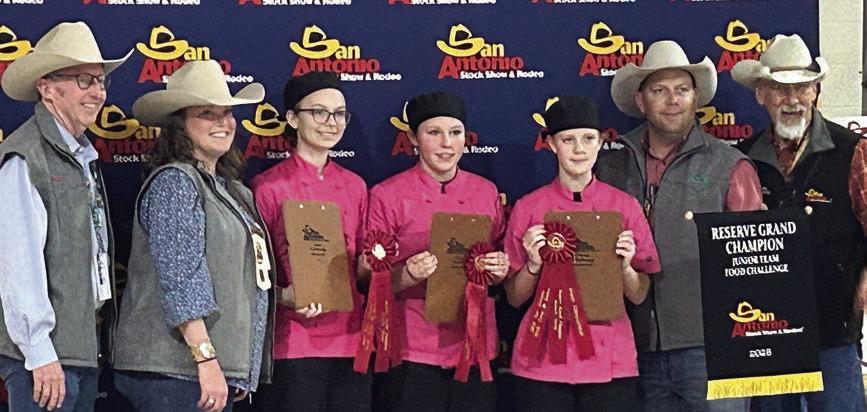 Simmer Do wn – (from left, flanked by two San Antonio Livestock Show representatives on each side) Tatum Fritsch, Ally Kibby and Sawyer Mau. The team won reserve champion in the junior division.