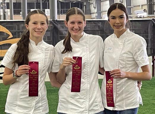 3 Girls in Chef Coats – (from left) Elenor Carey, Elena Supak and Tori Newton. The team placed second in senior healthy desserts.