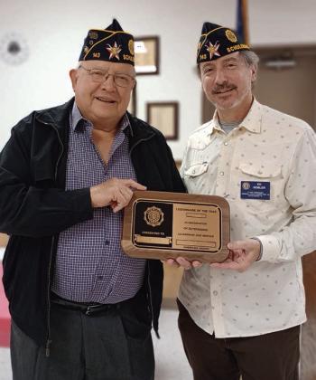 Post 143 Adjutant Dennis Muhlstein (left) accepts the Legionnaire of the Year award from First Vice Commander Ed Semler.