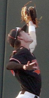 Zane Brenek reaches up to snag a fly ball in the right field corner in the second inning. Sticker Photo By Darrell Vyvjala