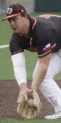 Third baseman Tyson Wagner scoops the ball up for a force out in the fourth. Sticker Photo By Darrell Vyvjala