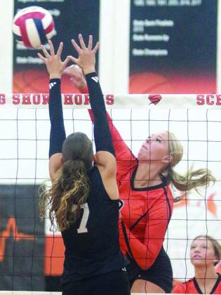 Aubryn Janda puts down a kill in the first set Thursday. Sticker Photo By Darrell Vyvjala