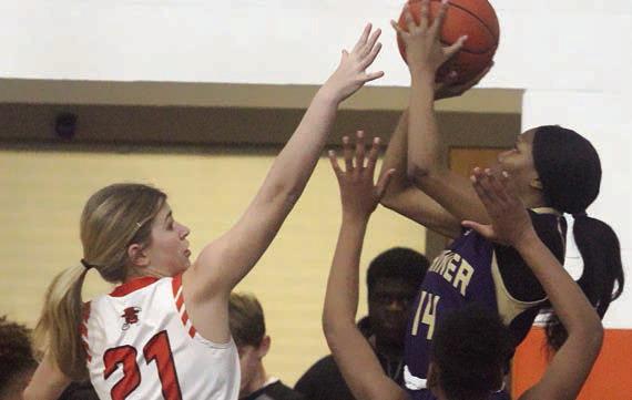 Chayse Deagen defends a Lady Comanche shot in the first half. Sticker Photo By Darrell Vyvjala