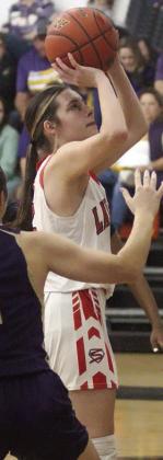 Fay Kutac scores in the lane on an inbound play in the second half against Shiner. Sticker Photo By Darrell Vyvjala