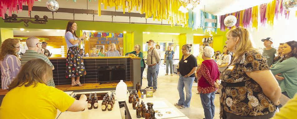 And Then’s founder and executive director Erin Wotipka leads the tour for participants during the grand opening event.