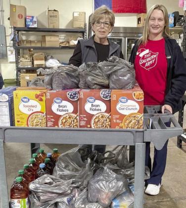 Board members of the La Grange branch of the Salvation Army donated 223 pounds of food the La Grange Food Pantry. Shown with the donated items are board members (from left) Sally Garrett and Krystal Seger.