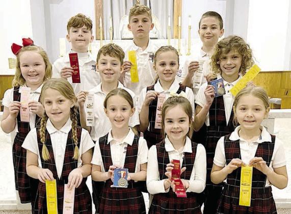 Grades 1-4 winners – (front row, from left) Emileigh Divin, Ree Lichnovsky, Paetyn Keys, Ellie Klein, (middle row) Abigail McBride, Brody Lewis, Addison Johnson, Lane Schiffli, (back row) Adam Reeves, Jack Schiffli and Micah Garcia.