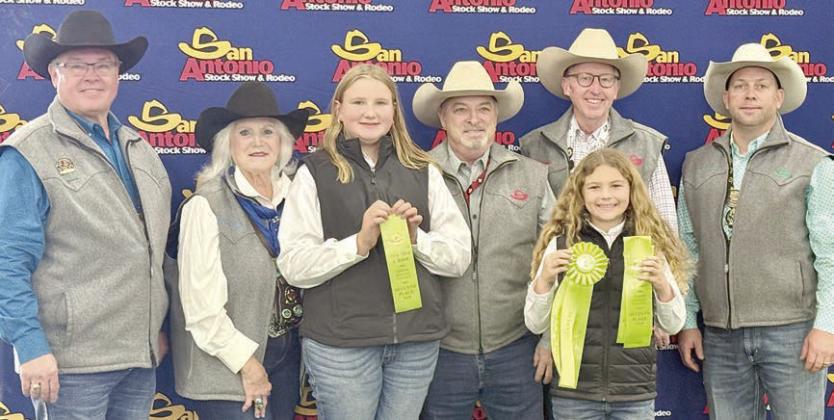 7th Place Team – Zoey Krenek (third from left) and Catelyn Bosl (front), shown with San Antonio Livestock Show &amp;amp; Rodeo representatives. Not shown are Abraham McBride and Abigale McBride.