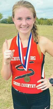 Taylor Limbaugh shows off the first-place medal she earned Monday