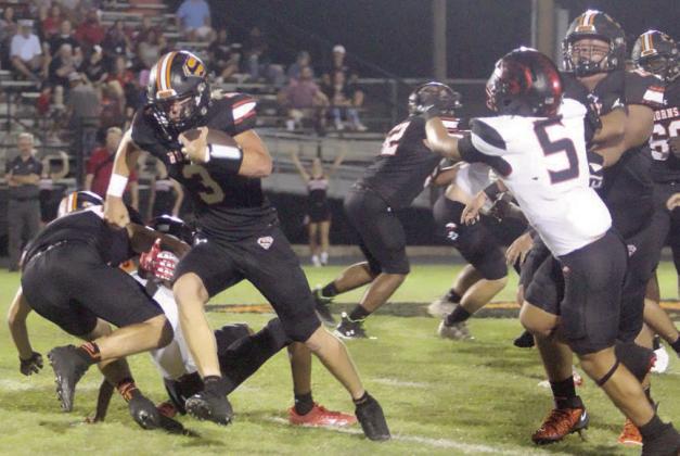 Blocks by Calvin Thompson (right) and Dean Bradley (left) spring Aaron Janecek for a 20-yard gain in the second quarter. Sticker Photo By Layne Vyvjala