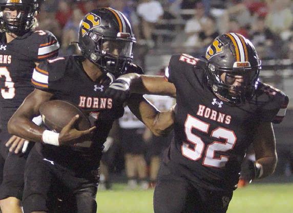 Da’Terrion Houston follows Austin Toro (No. 52) as he heads to the end zone in the first quarter. Sticker Photo By Layne Vyvjala