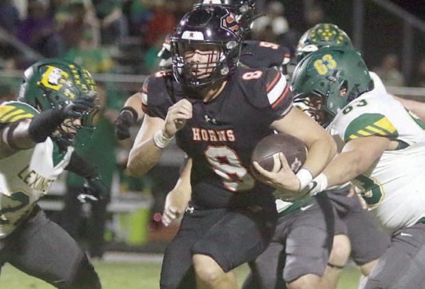 Owen Brenek gets by a pair of Eagle defenders on his way to a 24-yard touchdown run in the first quarter. Sticker Photo By Darrell Vyvjala