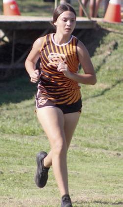 Silvia Cortez heads uphill after crossing the bridge on the first lap. Sticker Photo By Darrell Vyvjala