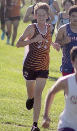 Jamison Bennett strides downhill on the north side of the Sports Complex. Sticker Photo By Darrell Vyvjala