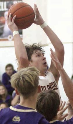 Aaron Janecek goes up in traffic for a bucket in the third quarter Friday. Sticker Photo By Darrell Vyvjala