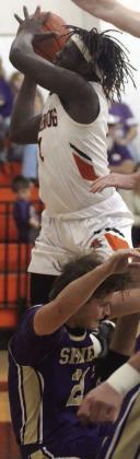 Rodney H Walton scores after colliding with a Comanche, leading to a three-point play in the first quarter. Sticker Photo By Darrell Vyvjala