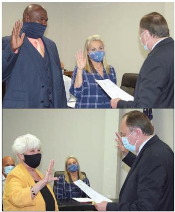 SWEARING IN – Top photo: Justice of the Peace Dan Mueller conducts the oath of office to Alderman Place 1 Greg Thomas (left), who takes over the seat vacated by Chip Bubela, and incumbent Alderman Place 2 Wendy Fietsam. Bottom photo: Mayor Elaine Kocian is sworn in by Mueller. Sticker Photos By Darrell Vyvjala