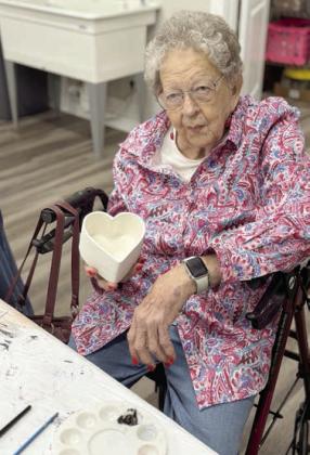 Artful Fridays – Irene Janda holds a bisque bowl as she contemplates her color scheme for the glaze. It’s sure to be pretty – she has a creative imagination. Janda is one of many seniors who participate in the Artful Fridays at the Arts for Rural Texas campus.